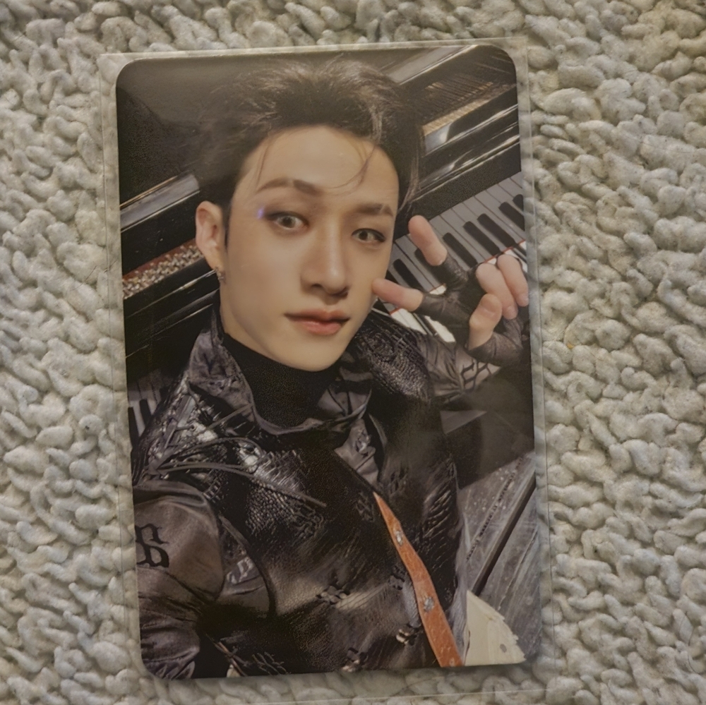 K-Pop Idol Photocard with Dark Leather Jacket and Piano Background